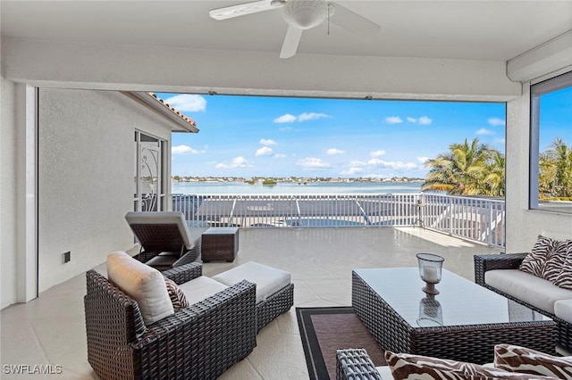 view of patio / terrace featuring a water view, outdoor lounge area, and ceiling fan