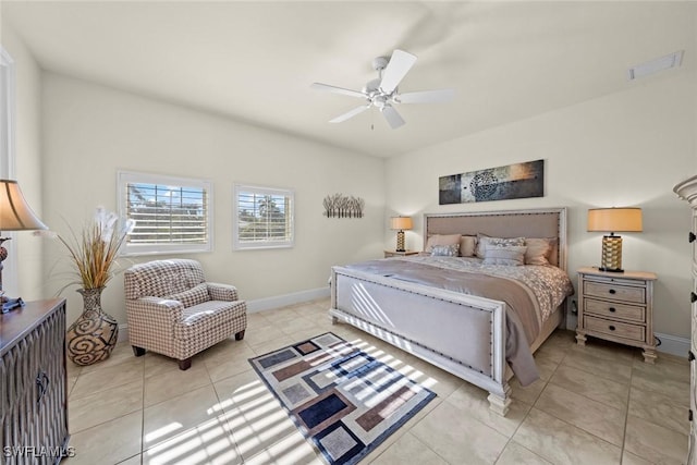 tiled bedroom featuring ceiling fan