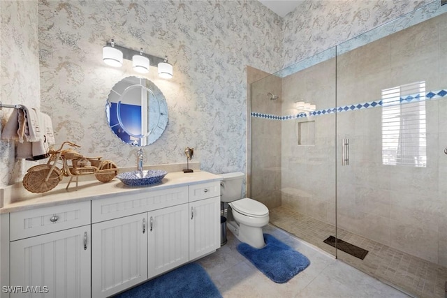 bathroom with vanity, a shower with shower door, tile patterned floors, and toilet