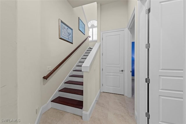 staircase featuring tile patterned floors