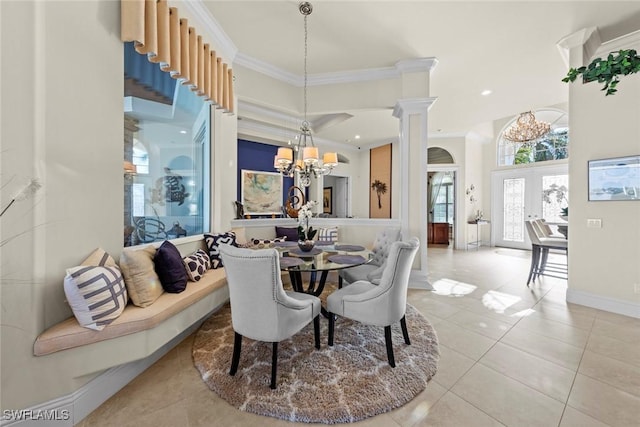 tiled dining area with decorative columns, crown molding, an inviting chandelier, and french doors