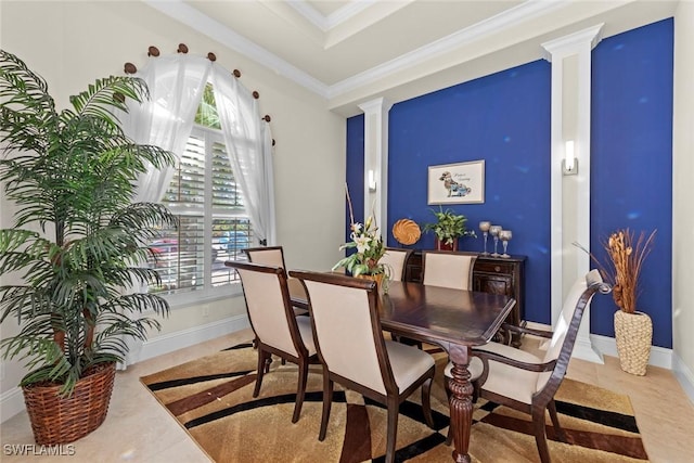 tiled dining space featuring ornamental molding, a tray ceiling, and ornate columns