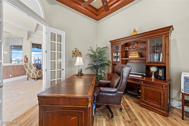 office area with ornamental molding, coffered ceiling, ceiling fan, beam ceiling, and light hardwood / wood-style flooring