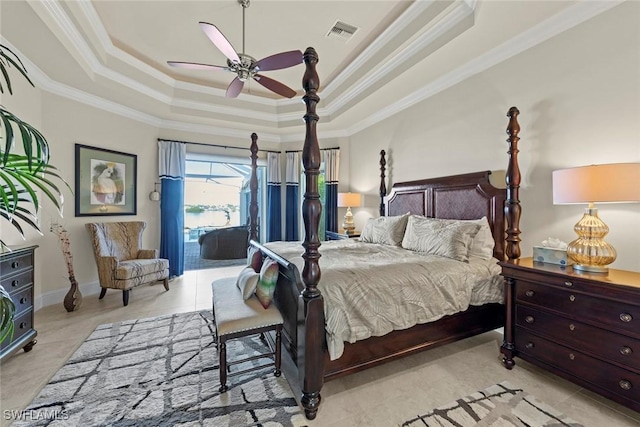 tiled bedroom with crown molding, access to exterior, and a tray ceiling