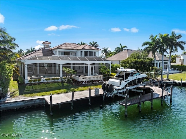 view of dock with a lawn, glass enclosure, and a water view