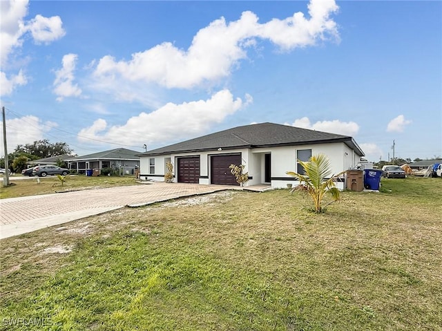 view of front of house featuring a garage and a front lawn