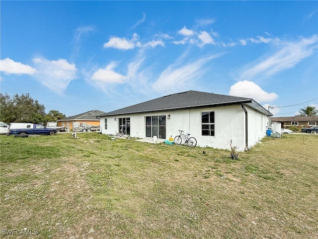 rear view of property featuring a yard