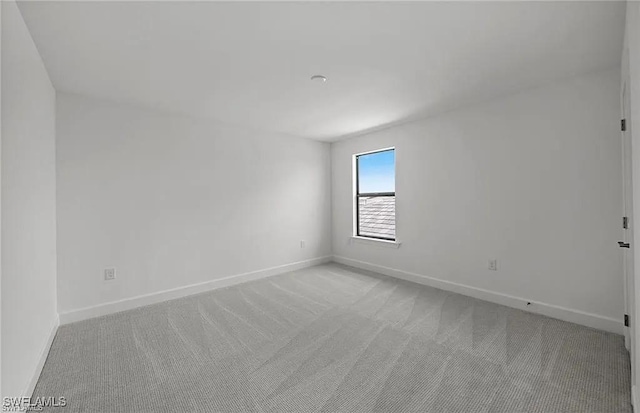 unfurnished room with light carpet