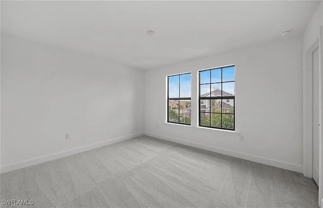 empty room featuring light colored carpet