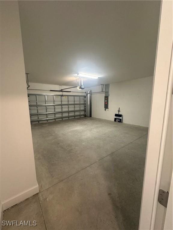 garage with a garage door opener and electric panel