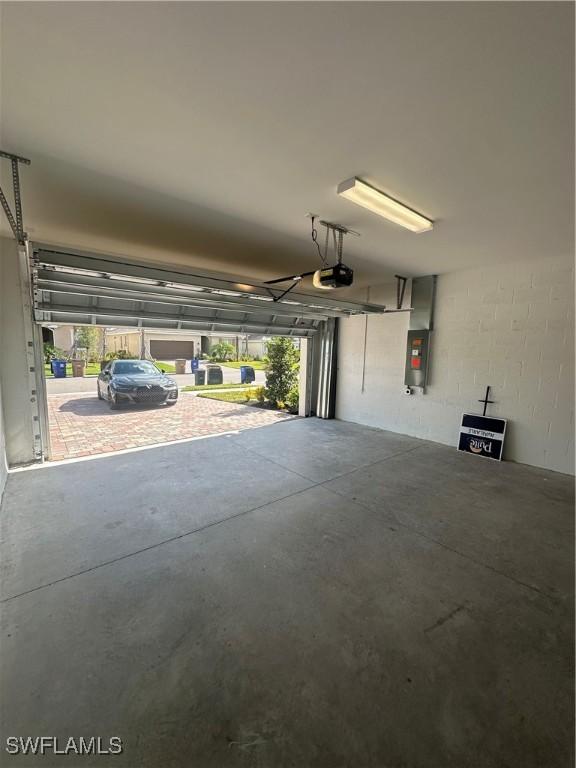 garage featuring a garage door opener and electric panel