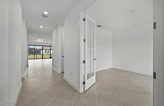 hallway with light tile patterned flooring