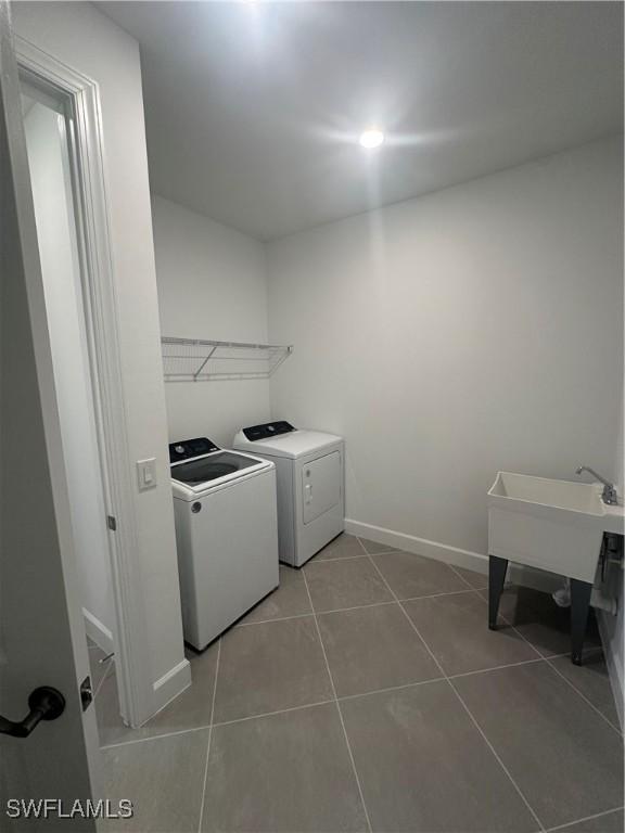 laundry room featuring tile patterned flooring and washer and dryer