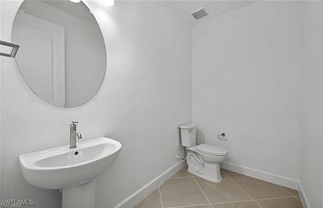 bathroom with tile patterned flooring, sink, and toilet