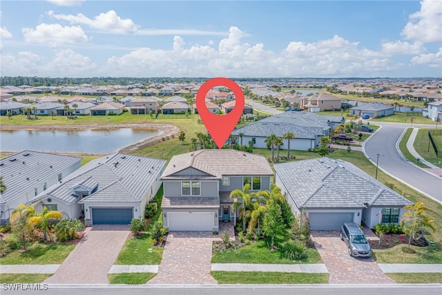 drone / aerial view with a residential view and a water view