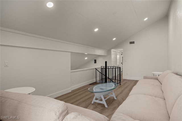 living room with hardwood / wood-style flooring and vaulted ceiling