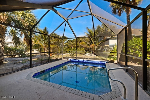 view of swimming pool featuring a lanai and a patio area