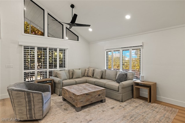 living room with high vaulted ceiling, ceiling fan, and light wood-type flooring