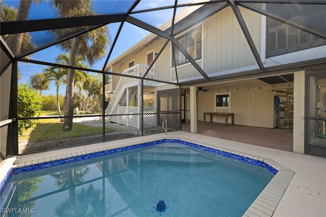 view of swimming pool featuring a patio and a lanai