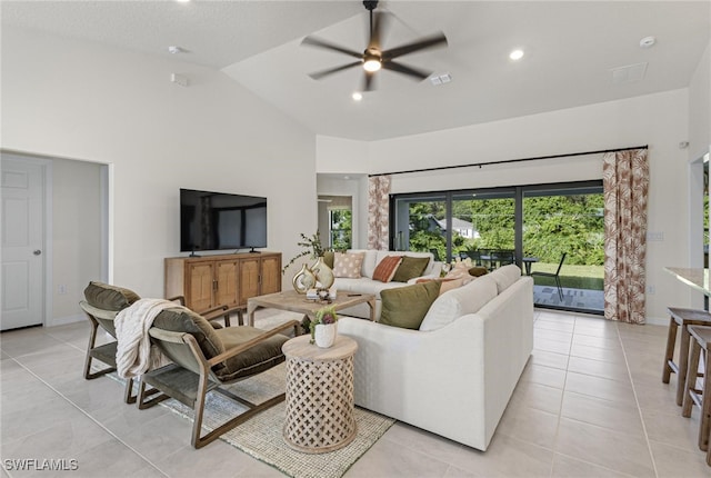 tiled living room featuring vaulted ceiling and ceiling fan