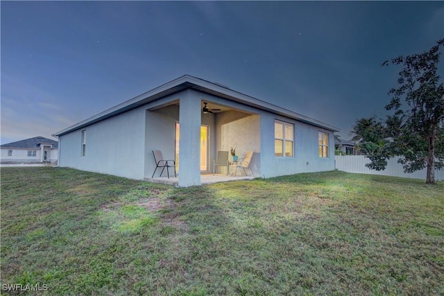 view of side of home featuring a patio area and a lawn