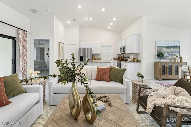 living room featuring high vaulted ceiling