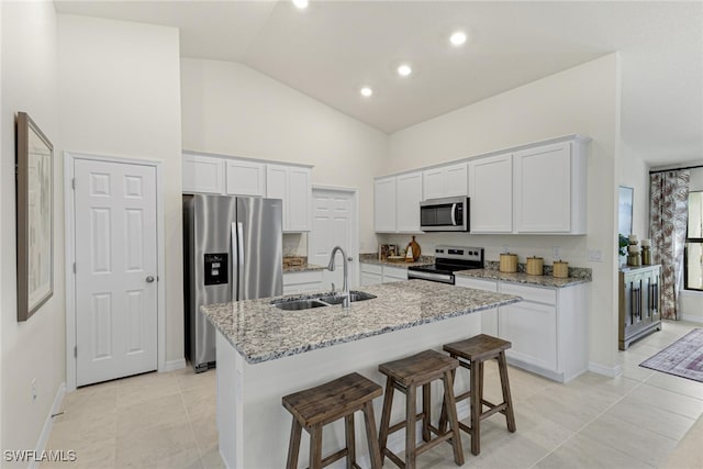 kitchen with sink, white cabinetry, appliances with stainless steel finishes, and a center island with sink