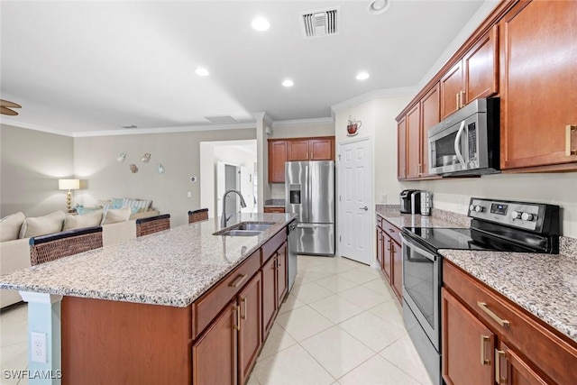 kitchen featuring visible vents, appliances with stainless steel finishes, ornamental molding, open floor plan, and a sink