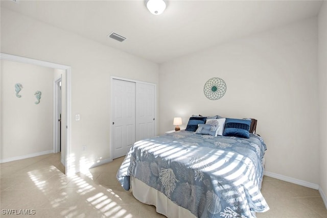 bedroom with a closet, visible vents, and baseboards