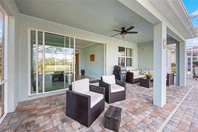 view of patio / terrace with an outdoor living space, area for grilling, and a ceiling fan