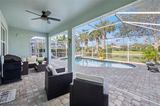 outdoor pool with a patio, outdoor lounge area, a grill, and glass enclosure