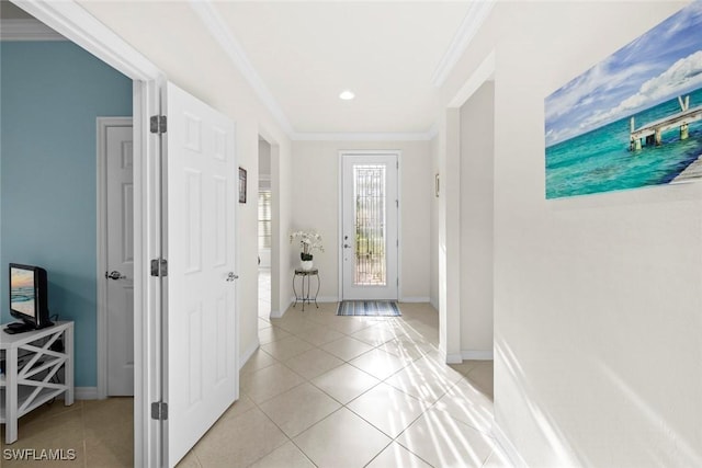 entrance foyer featuring light tile patterned floors, baseboards, and crown molding