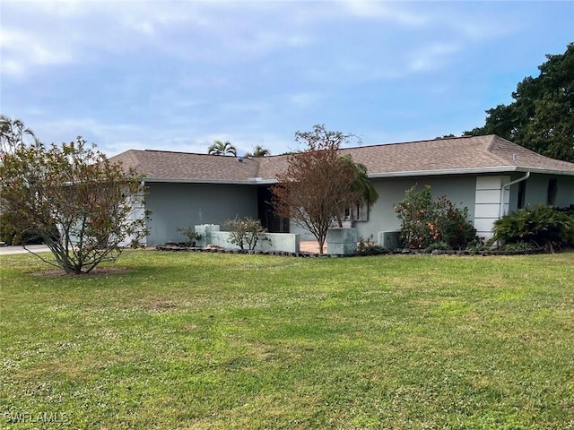 view of side of home with a lawn