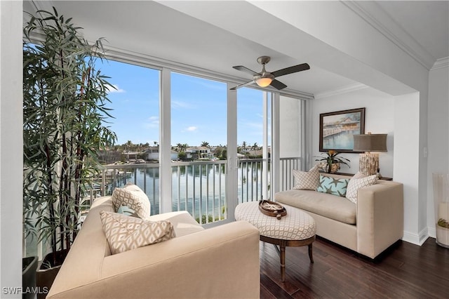 living room with dark hardwood / wood-style flooring, ornamental molding, expansive windows, and a water view