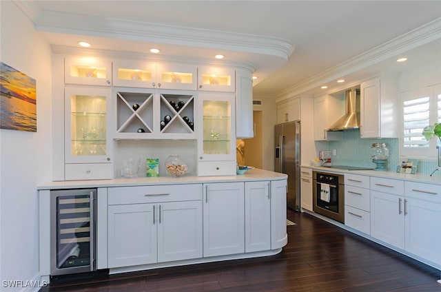 bar with wine cooler, wall chimney exhaust hood, white cabinetry, tasteful backsplash, and stainless steel appliances