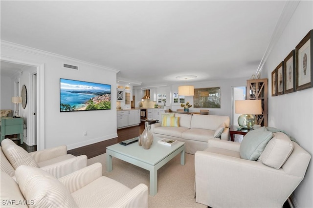 living room with ornamental molding and hardwood / wood-style floors