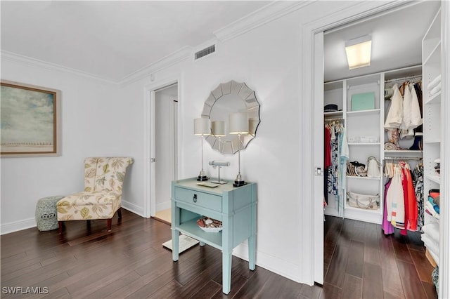 sitting room with ornamental molding and dark hardwood / wood-style floors