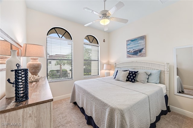 bedroom featuring light colored carpet and ceiling fan