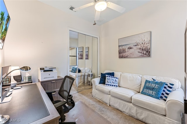 home office featuring light carpet and ceiling fan