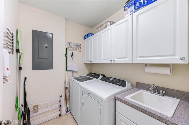 washroom with sink, cabinets, light tile patterned floors, electric panel, and washer and clothes dryer