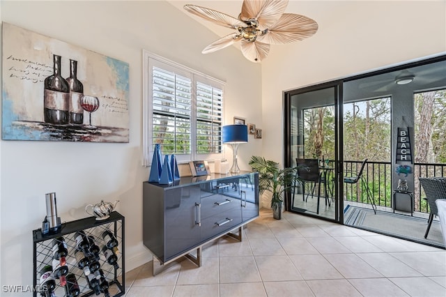 doorway to outside featuring light tile patterned floors and ceiling fan