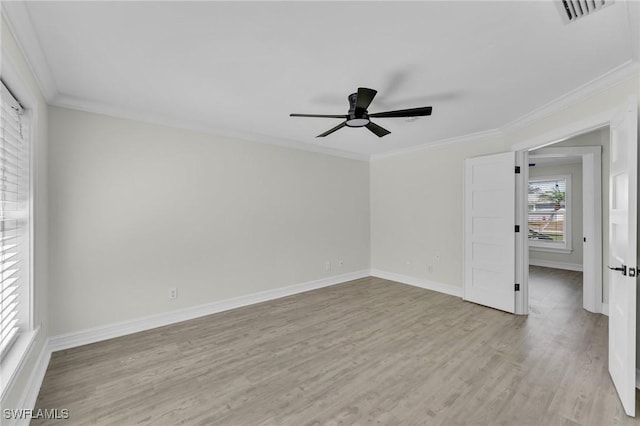 empty room with ornamental molding, ceiling fan, and light hardwood / wood-style flooring