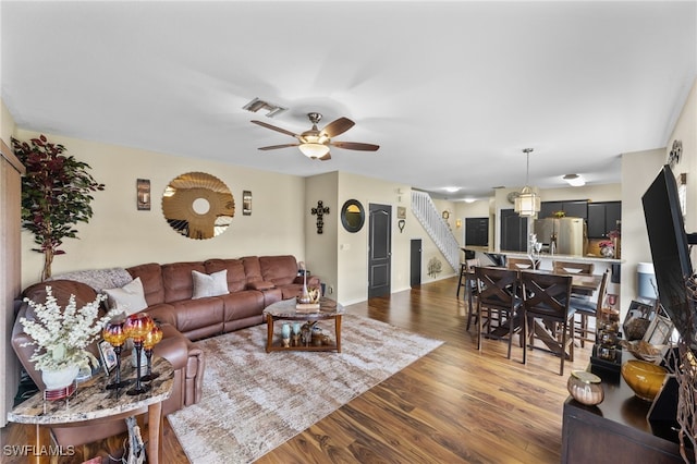 living room with dark wood-type flooring and ceiling fan