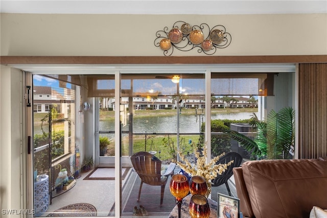 sunroom / solarium featuring a water view