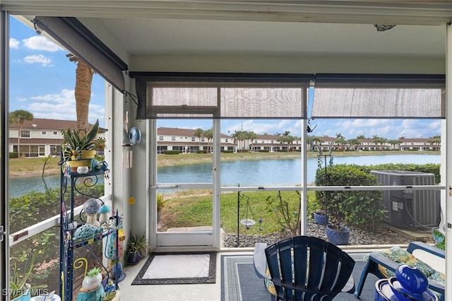 sunroom featuring a water view and a healthy amount of sunlight