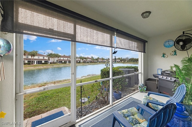 sunroom / solarium with a wealth of natural light and a water view