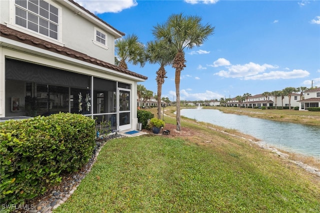 view of yard with a water view and a sunroom