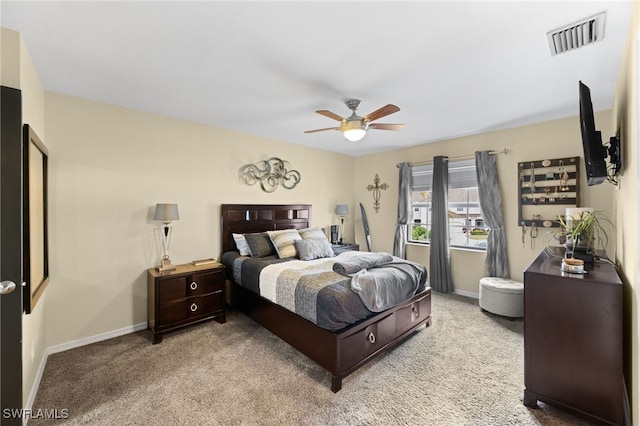 bedroom featuring light colored carpet and ceiling fan