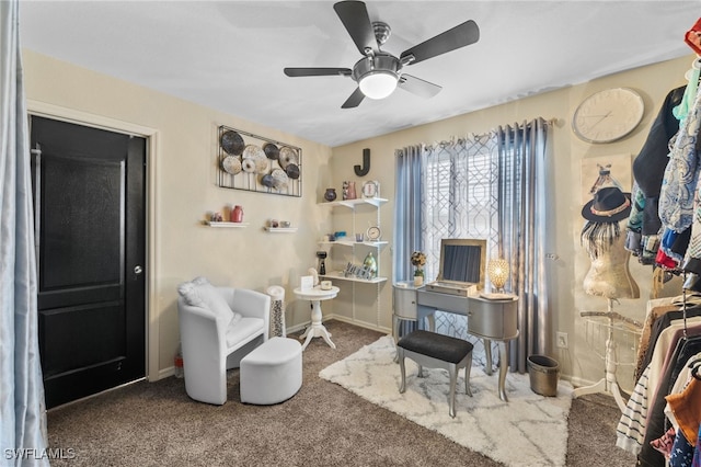 living area featuring carpet floors and ceiling fan