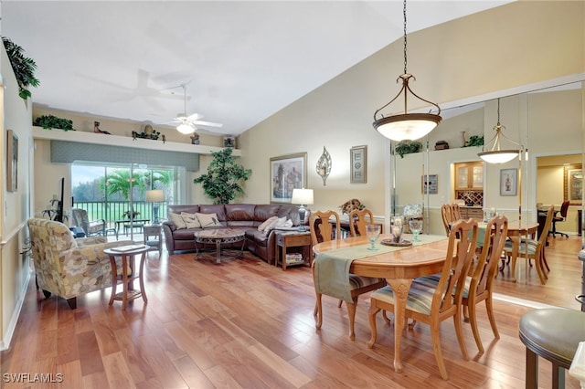 dining area featuring vaulted ceiling, hardwood / wood-style floors, and ceiling fan